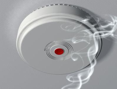 A smoke detector with a trail of smoke